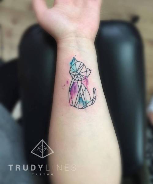 Little kitty tattoo on the left inner wrist. Tattoo artist:... geometric shape;small;violet;graphic;tiny;blue;polygon;pink;little;wrist;cat;green;illustrative;feline;corinaweikl;black;animal
